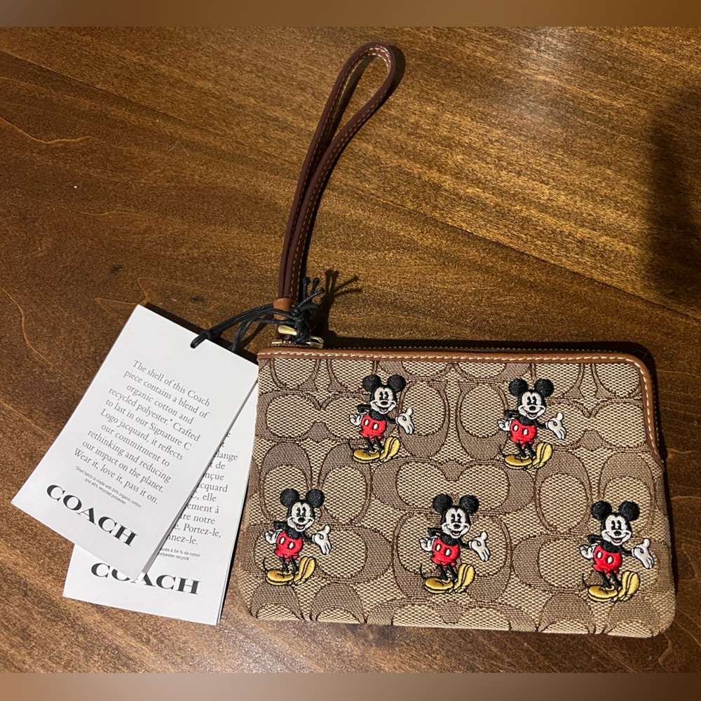 New with tags, never used, Coach Mickey Mouse Wristlet.